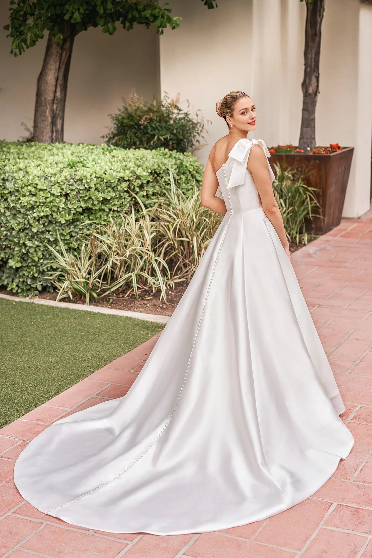 Asymmetric collar sleeveless backless bow shoulder strap and floor length wedding dress